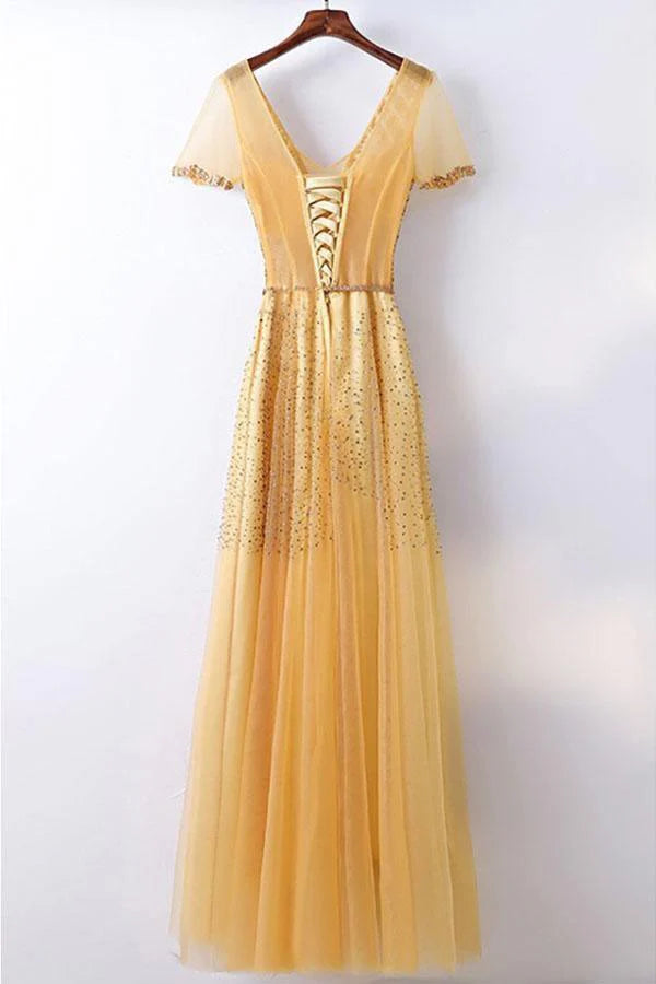 Side view of a woman in a dazzling A-line formal dress.