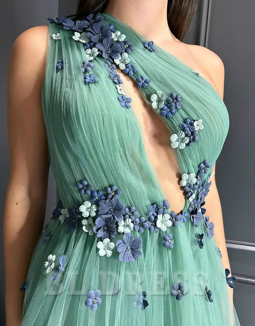 Close-up of the sparkly floral tulle fabric on the green dress.