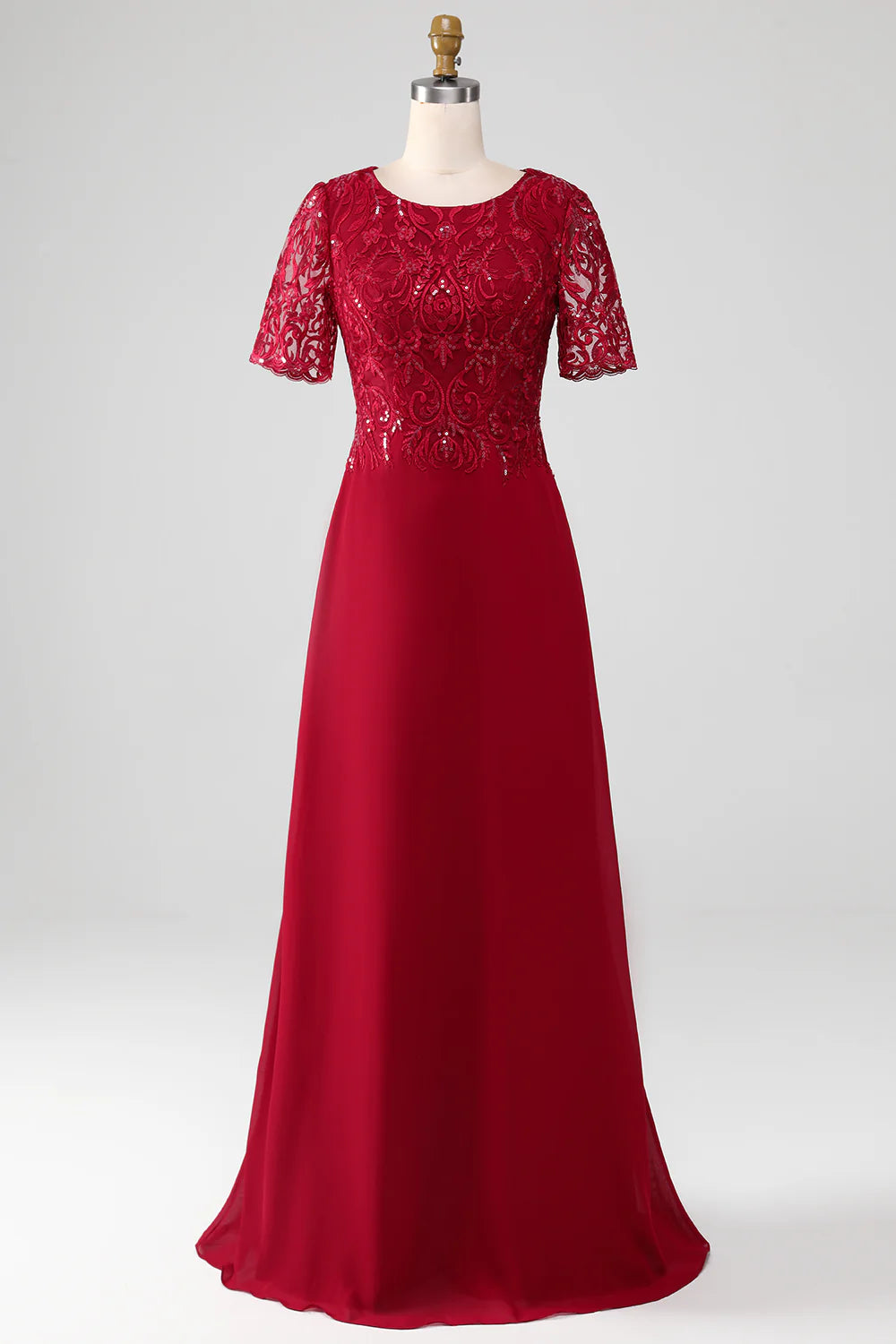 Woman wearing a burgundy A-line sequin Mother of the Bride gown.