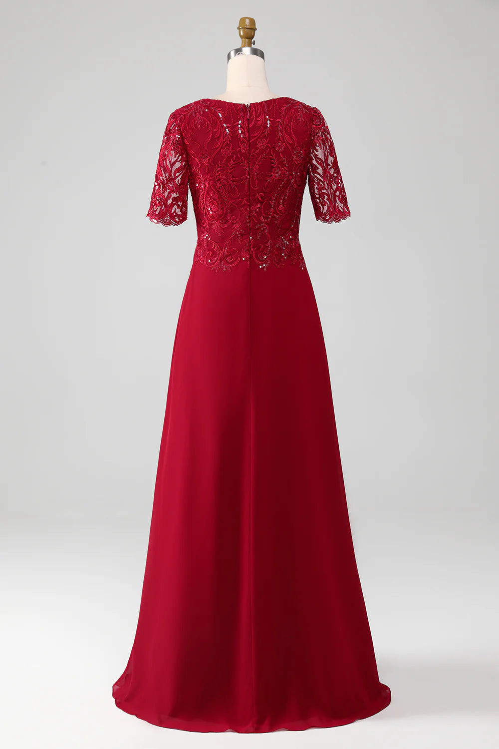 Close-up of sequin and applique details on a burgundy formal dress.