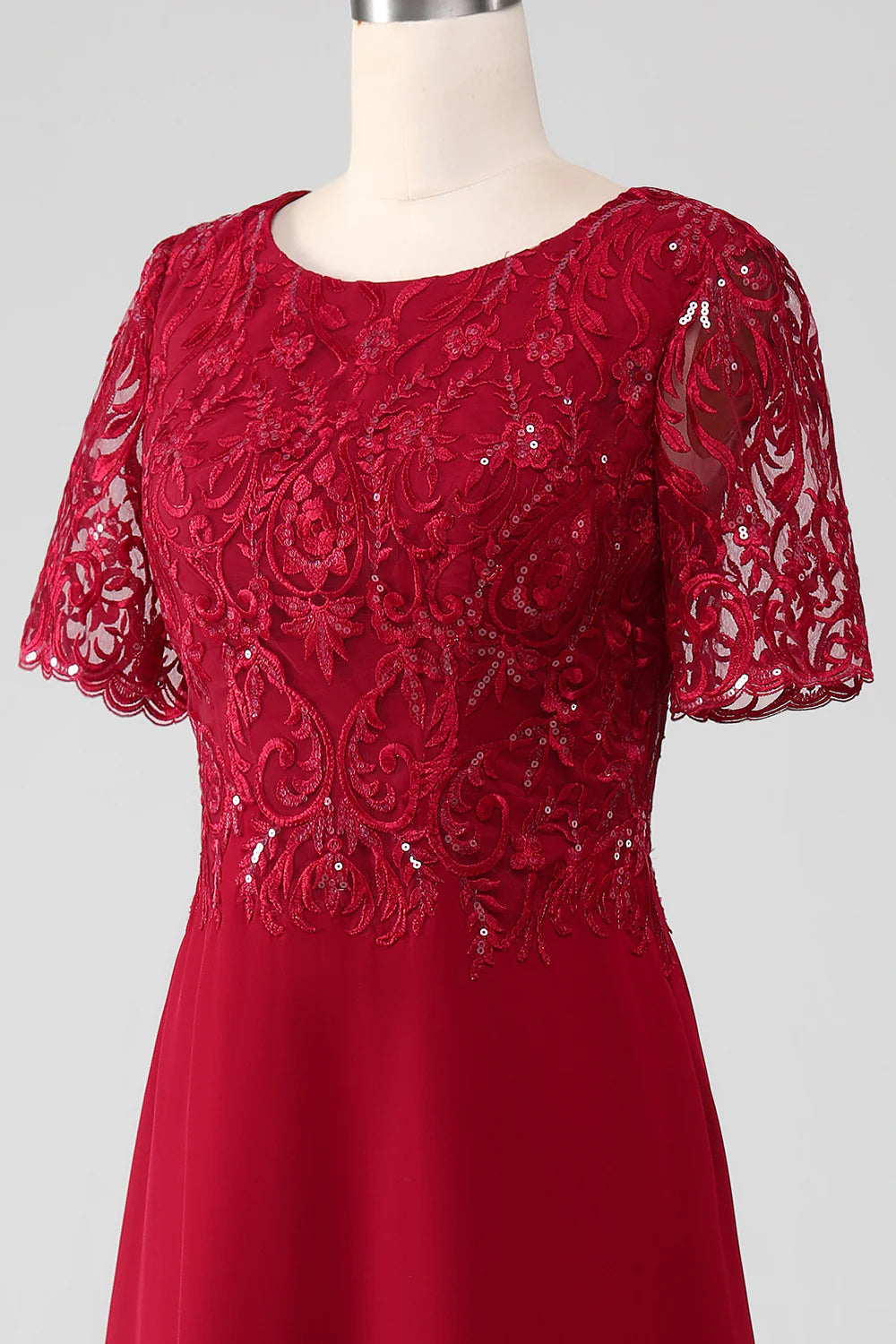 Side view of a woman in a sparkly burgundy Mother of the Bride dress.