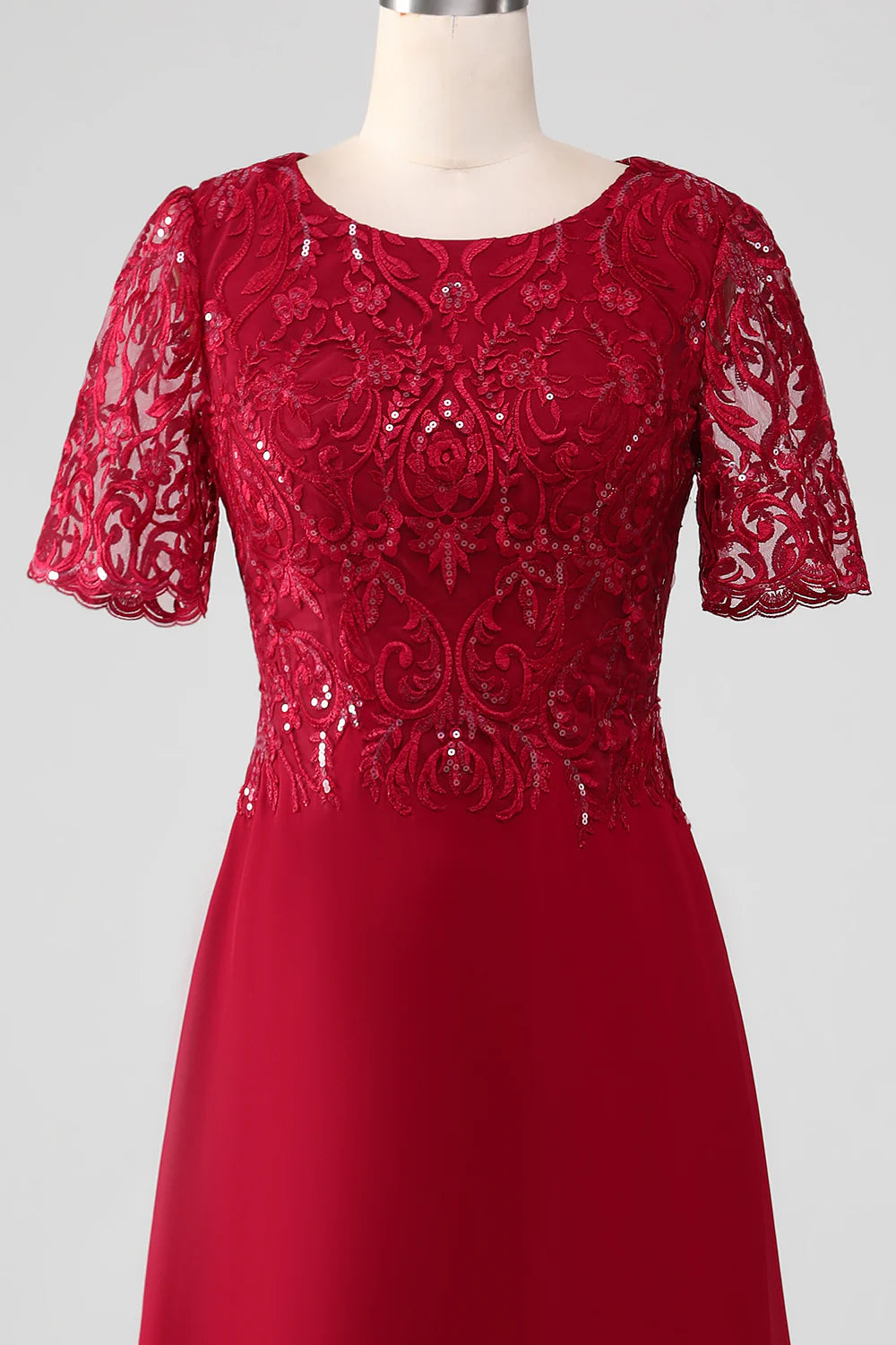 Full length view of a woman posing in a burgundy sequin A-line dress.