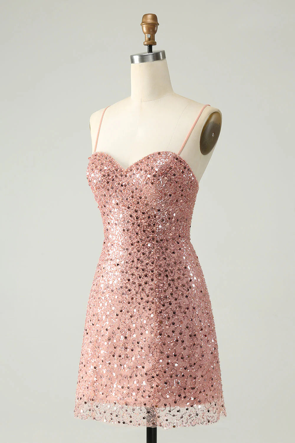 Woman posing in a blush sparkly A-line cocktail dress.
