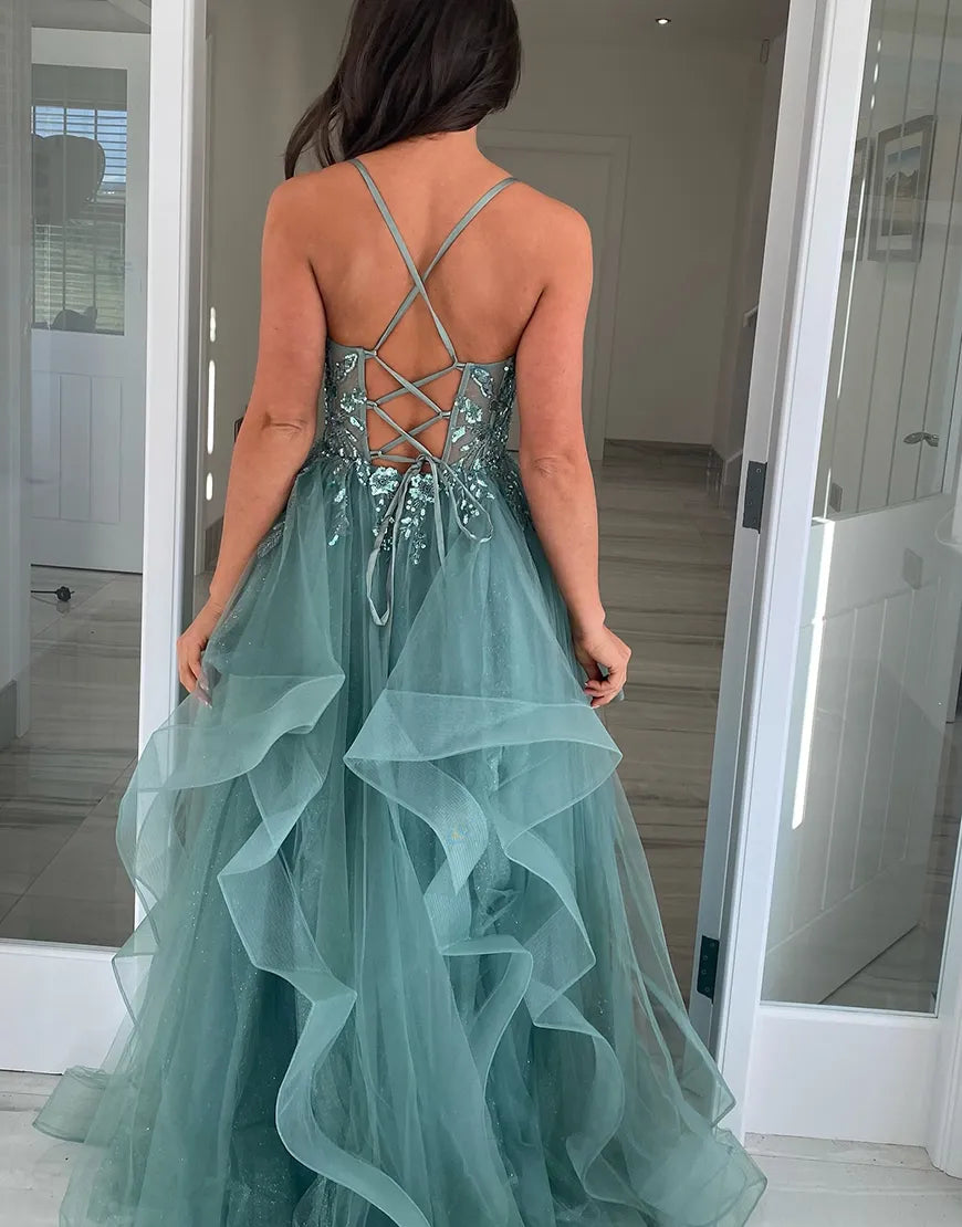 Back view of the navy A-line formal dress, showcasing ruffled tulle and long silhouette.