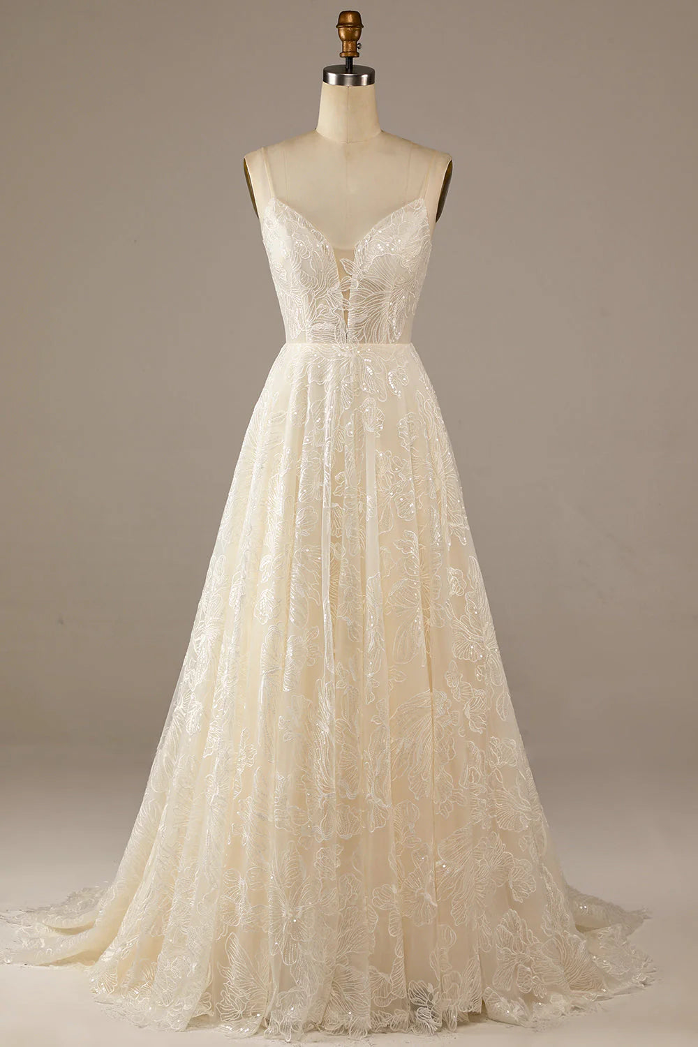 Full view of a sparkly A-line lace wedding dress with a sweetheart neckline and sweep train in ivory.