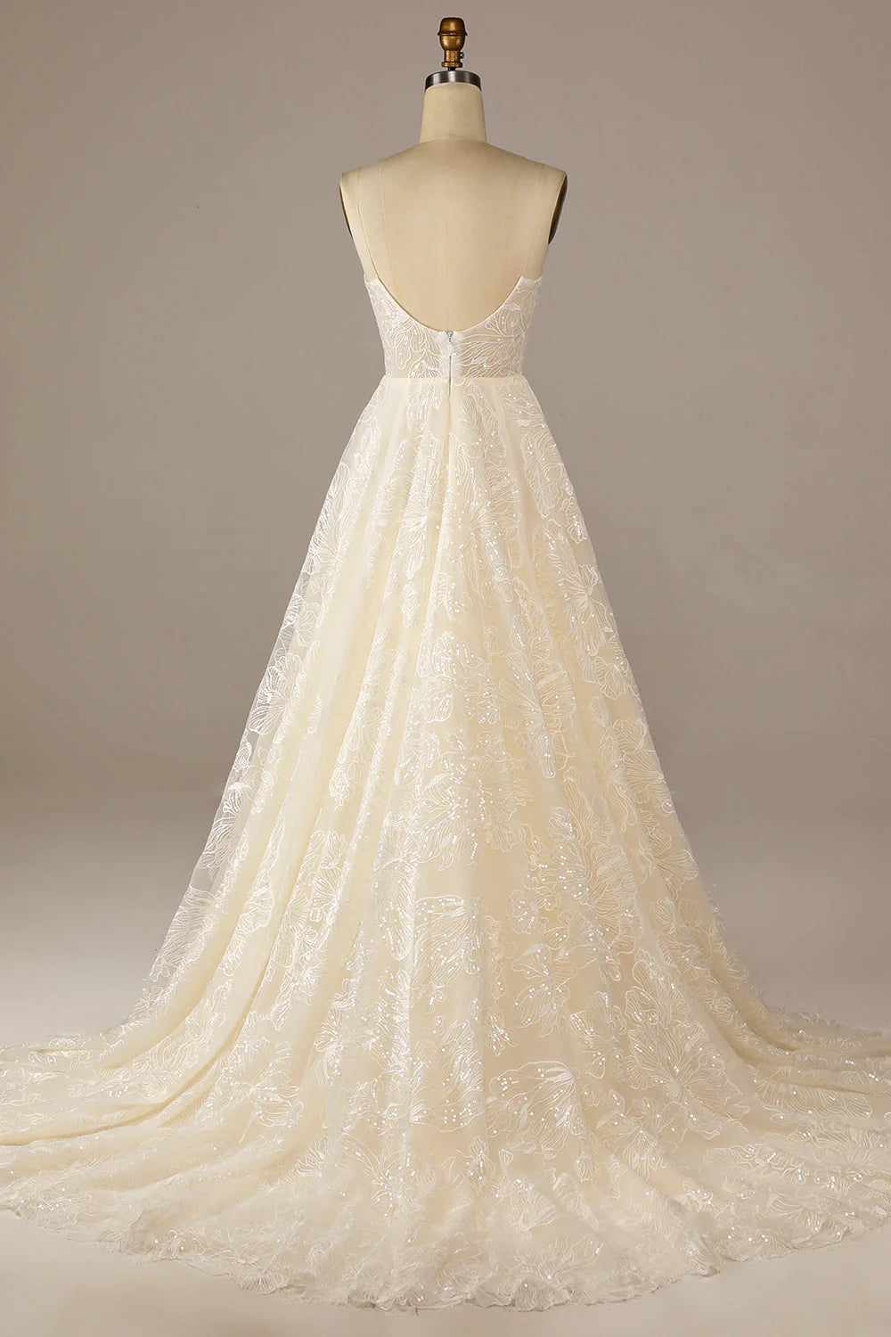 Close-up of the intricate lace and sparkling details on the ivory wedding dress.