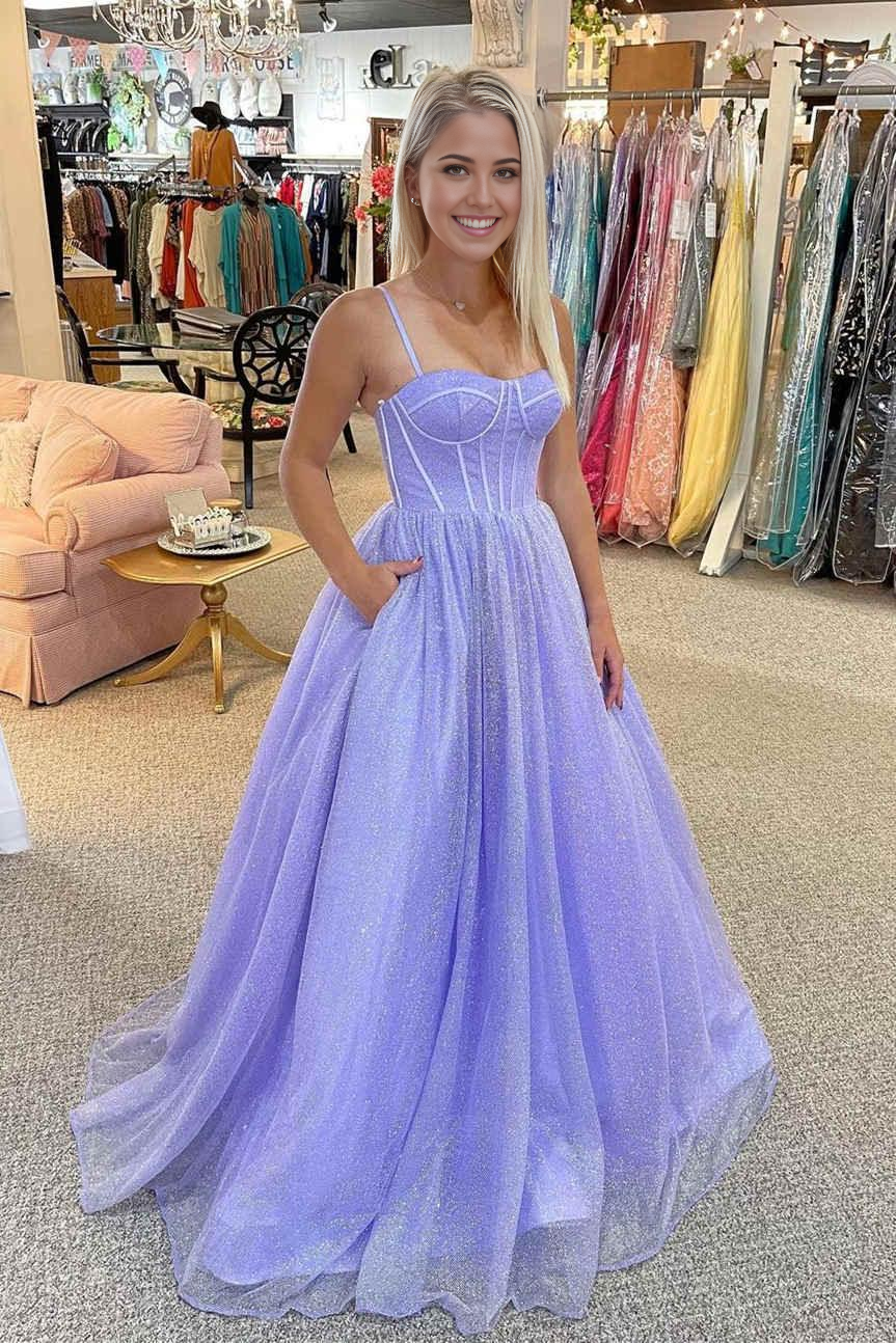 Model wearing a sparkly lilac A-line sweetheart tulle long prom dress with straps.