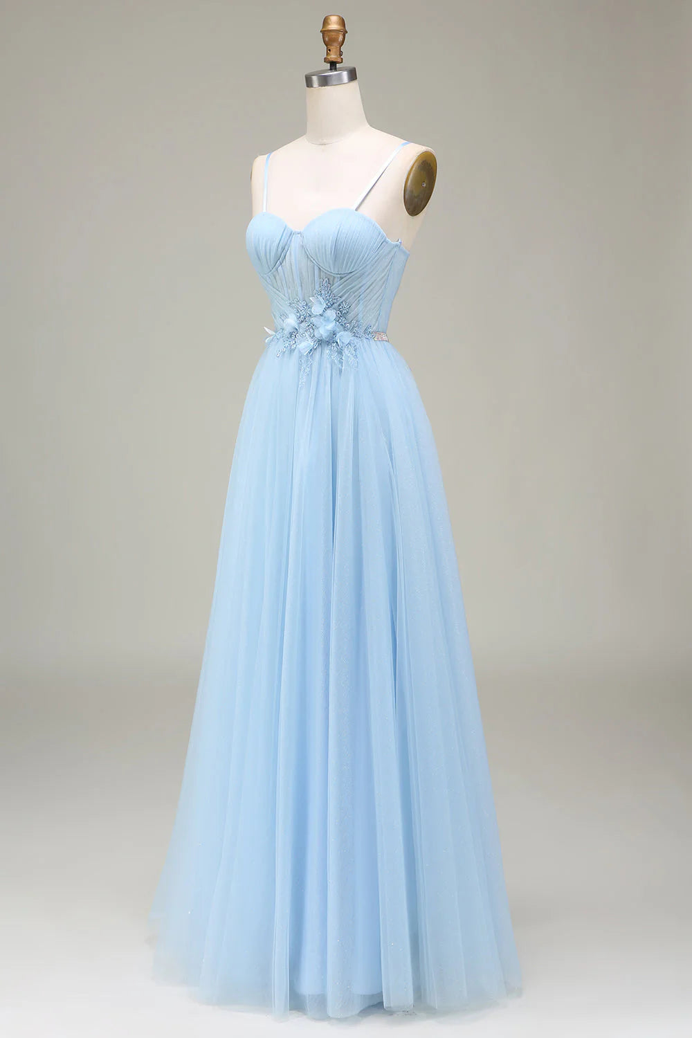 Close-up of the delicate appliques and sparkly tulle fabric on the prom dress.
