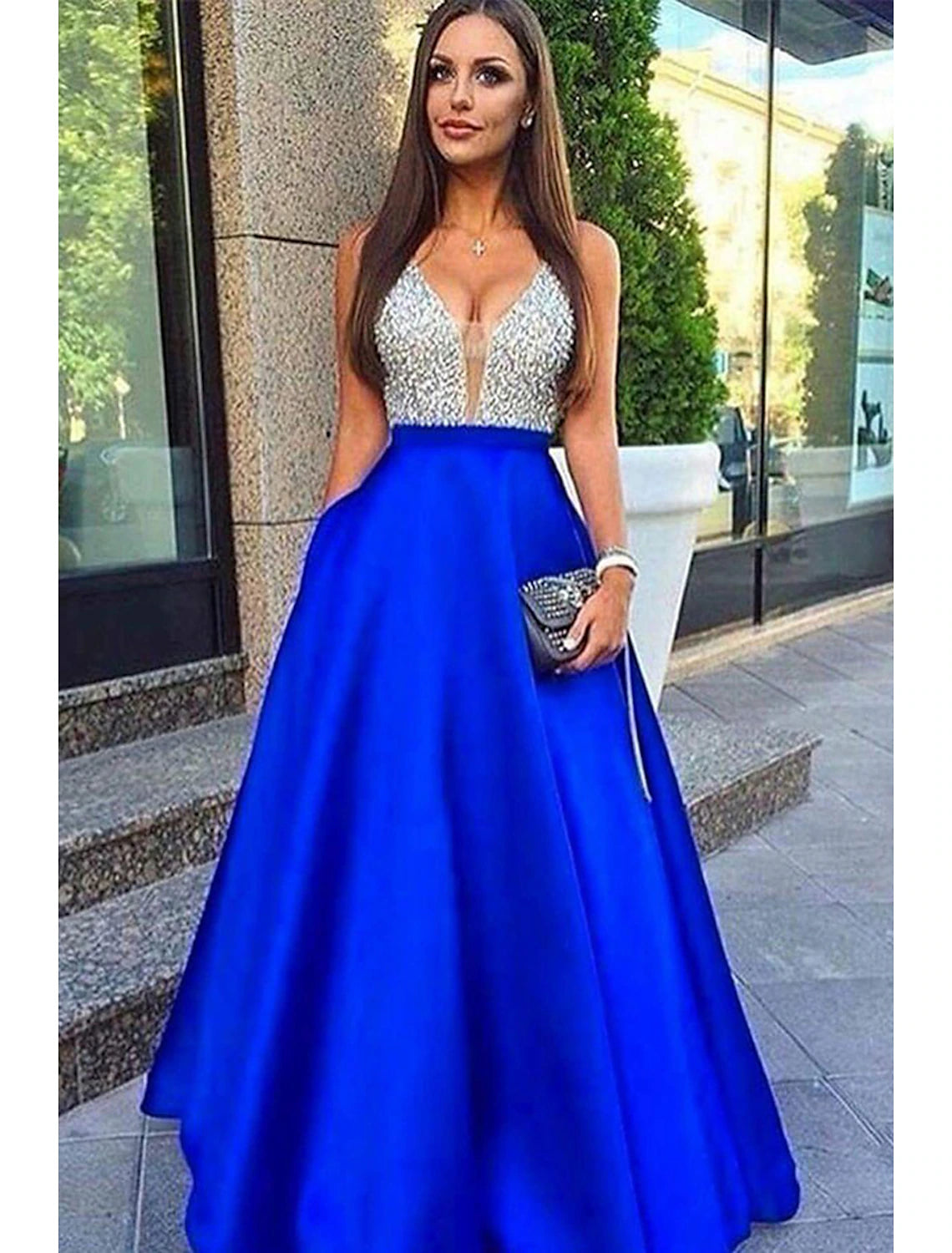 Model wearing a sparkly A-line V-neck floor-length prom dress with beading and pockets.