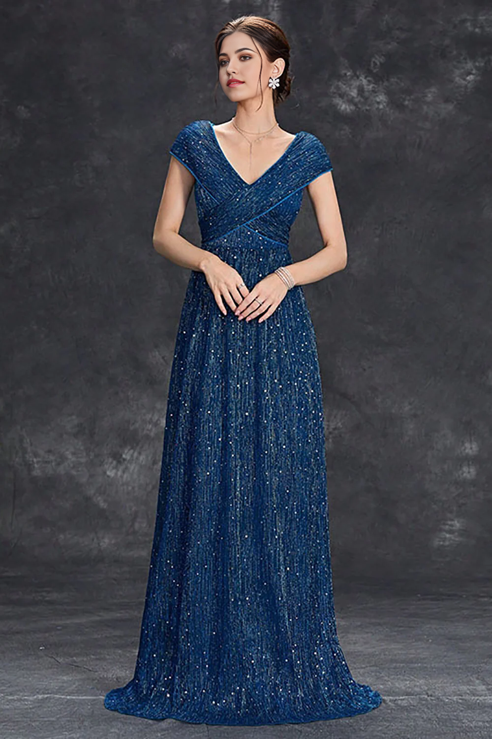 Woman wearing a sparkly A-line V-neck long formal dress.