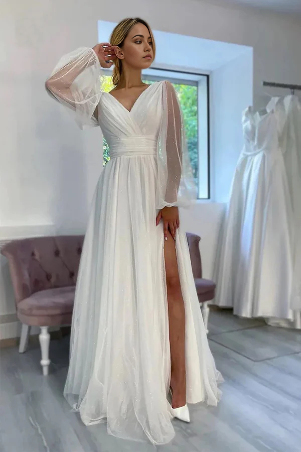 Back view of a sparkly A-line wedding dress with long sleeves.