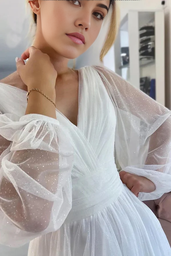 Side view of a bride wearing a sparkly A-line wedding dress.