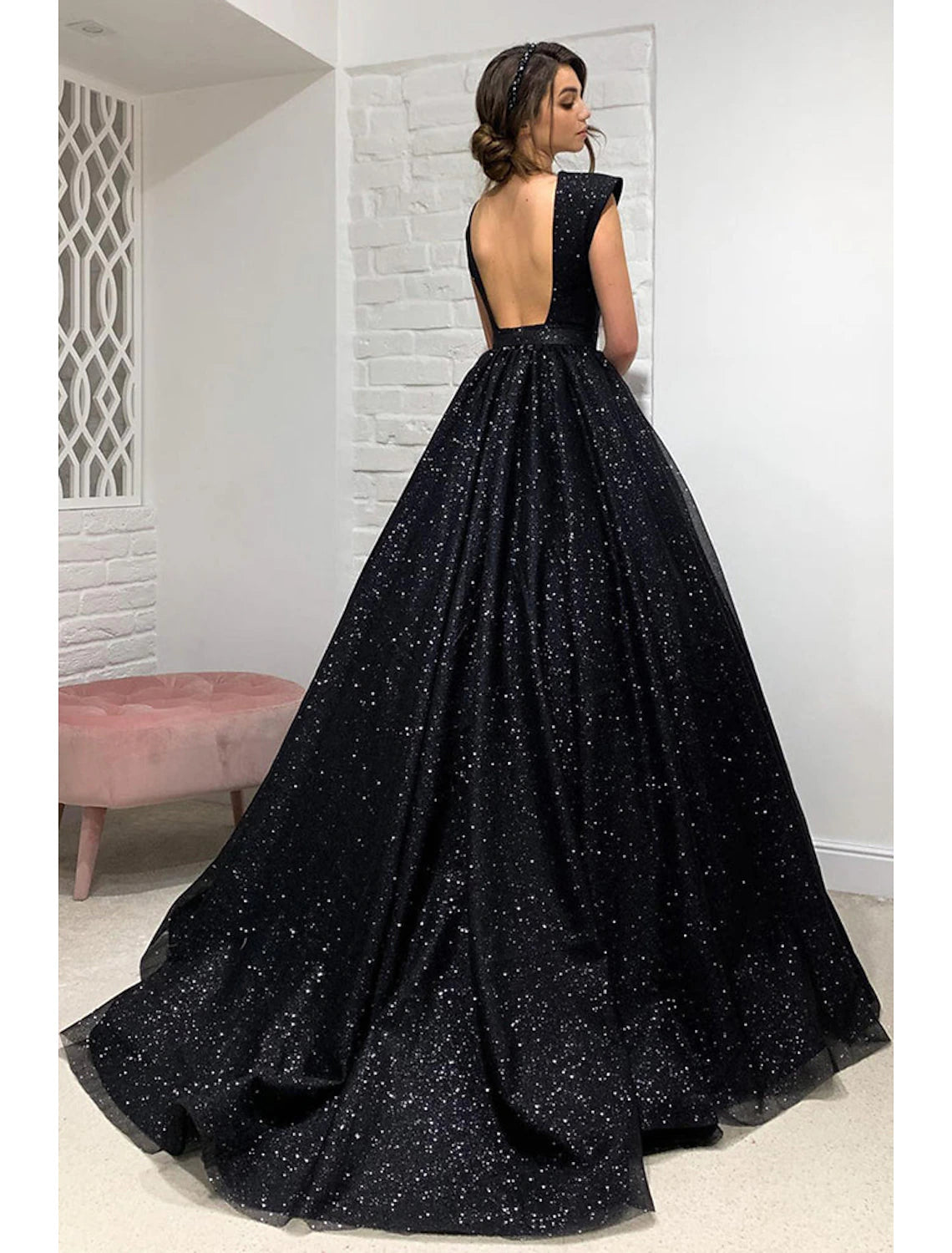Back view of elegant sleeveless prom dress with pleats.