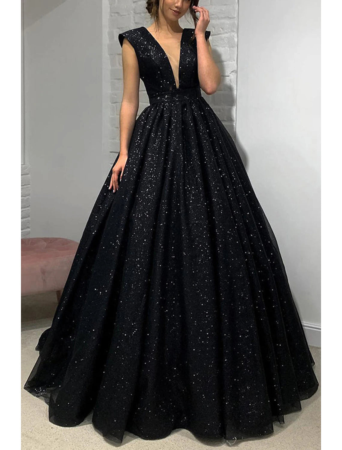 Side profile of shimmering formal gown with V-neck.