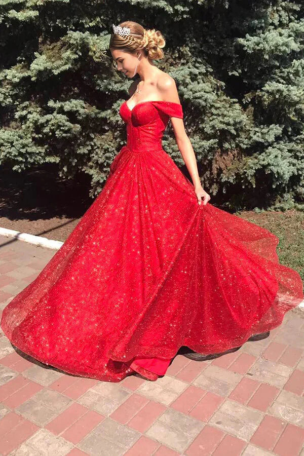 Close-up of the sparkly tulle fabric and off-shoulder detail of the red dress.