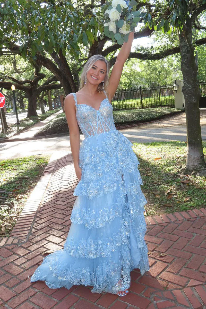 Full view of a light blue A-line tulle prom dress with a sweetheart neckline and sparkly appliques.