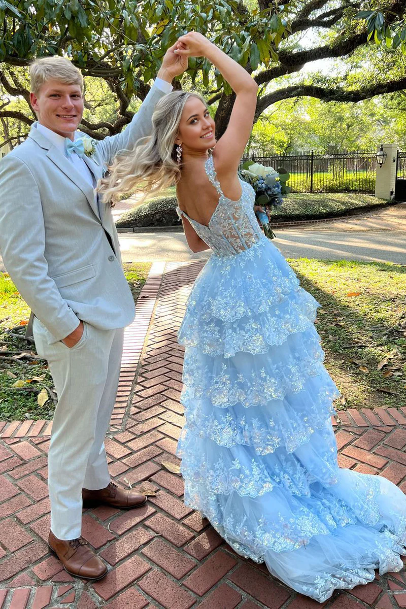 Close-up of the sparkly appliques and sweetheart neckline on the light blue tulle prom dress.