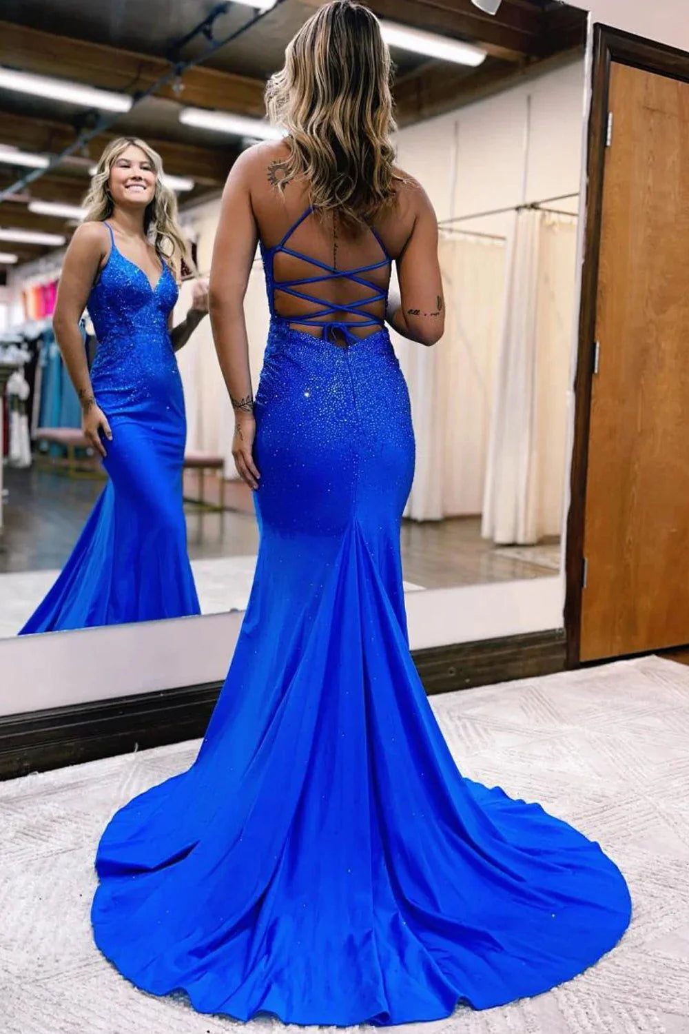 Close-up of the intricate beading and appliques on a mermaid formal gown.