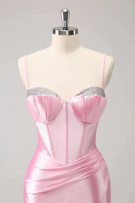 Model in a pink sparkly, beaded, tight V-neck spaghetti strap short homecoming dress.