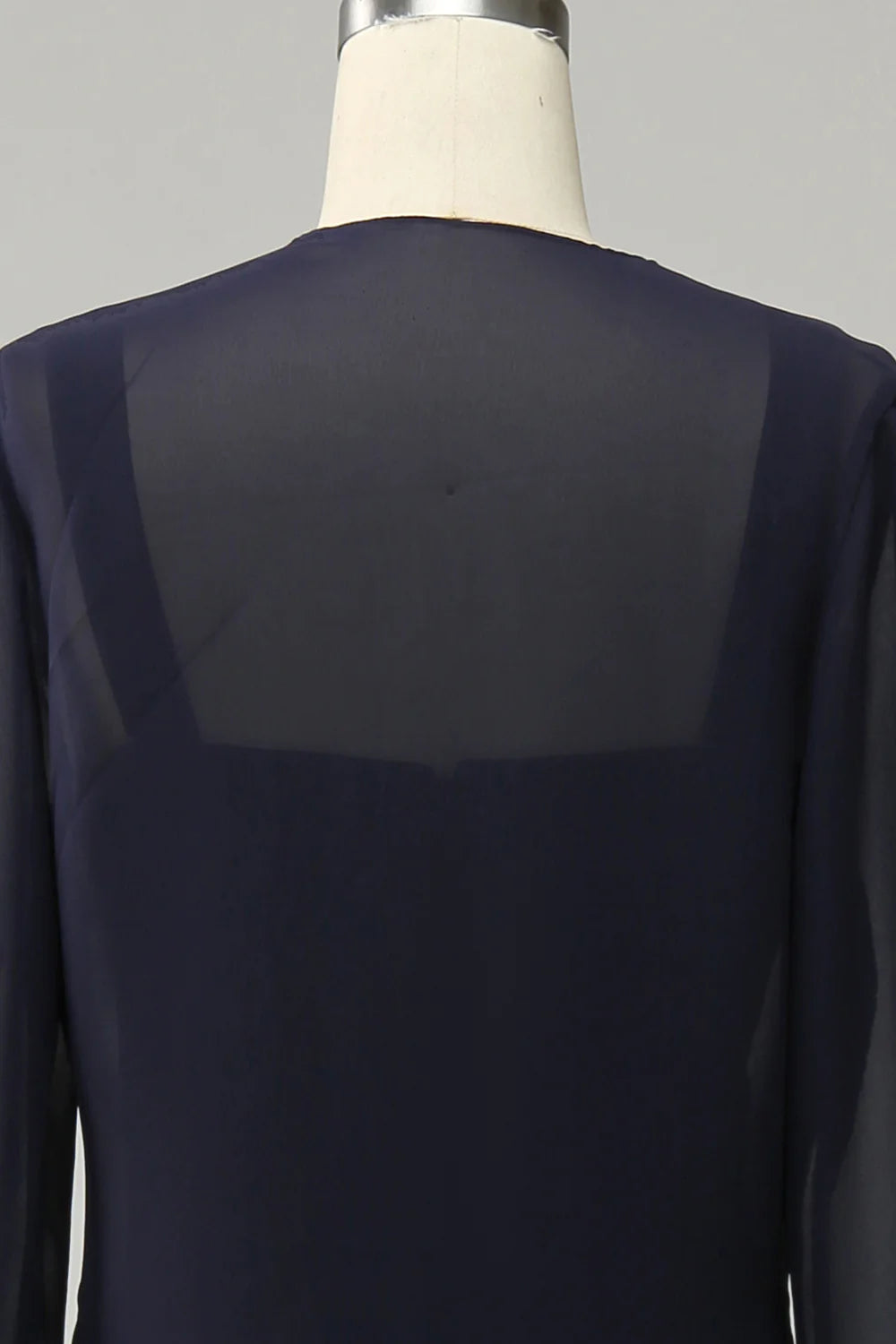 Detail of the V-neckline and beading on the navy blue formal gown.