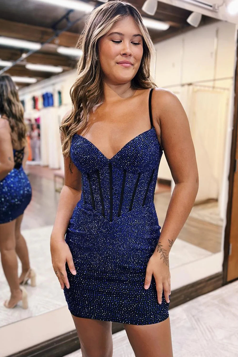 Full view of a model showcasing the sparkly beaded V-neck mini dress.