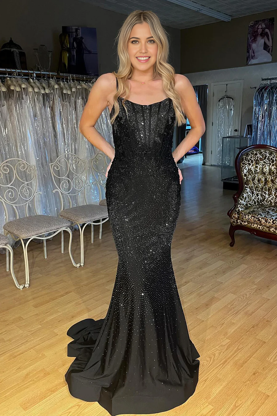 Model wearing a black sparkly mermaid V-neck prom dress.