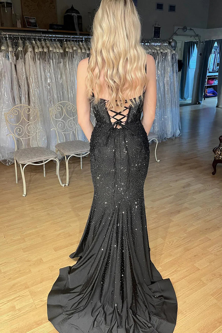 Elegant black sequin mermaid gown with V-neckline.