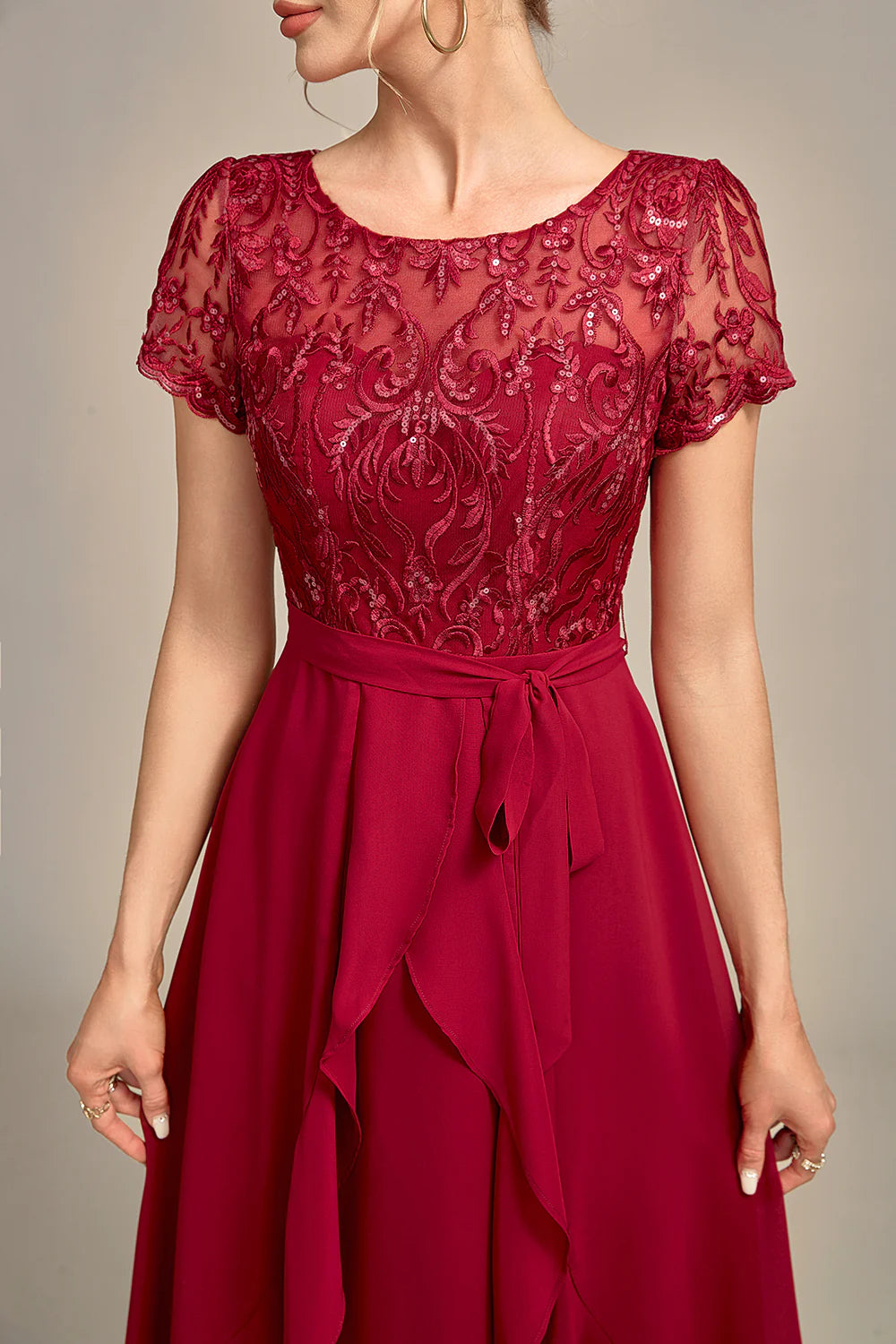 Sparkling burgundy V-neck dress with A-line skirt and sequin embellishments.