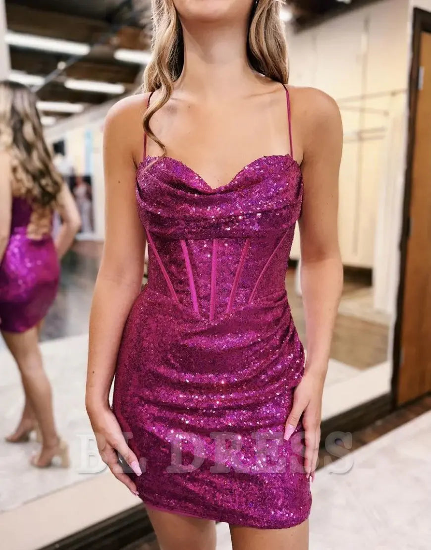 Back view of a model in a sparkly hot pink fitted dress, showcasing the short length.
