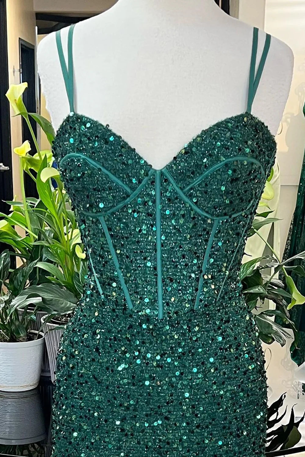 Back view of a sparkly mermaid prom dress, showcasing the corset detailing.