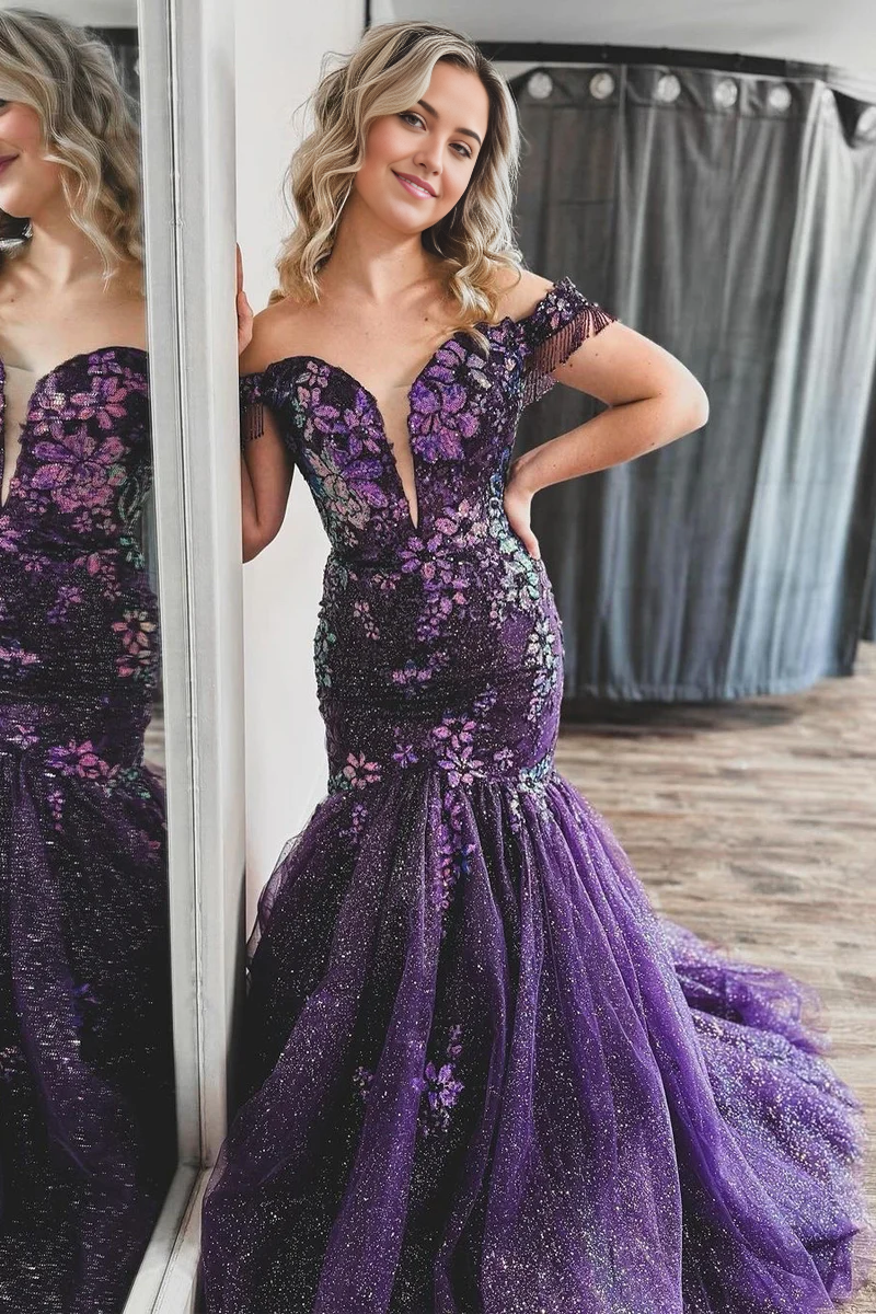 Model wearing a sparkly purple off-shoulder mermaid prom dress with sequin and lace details.