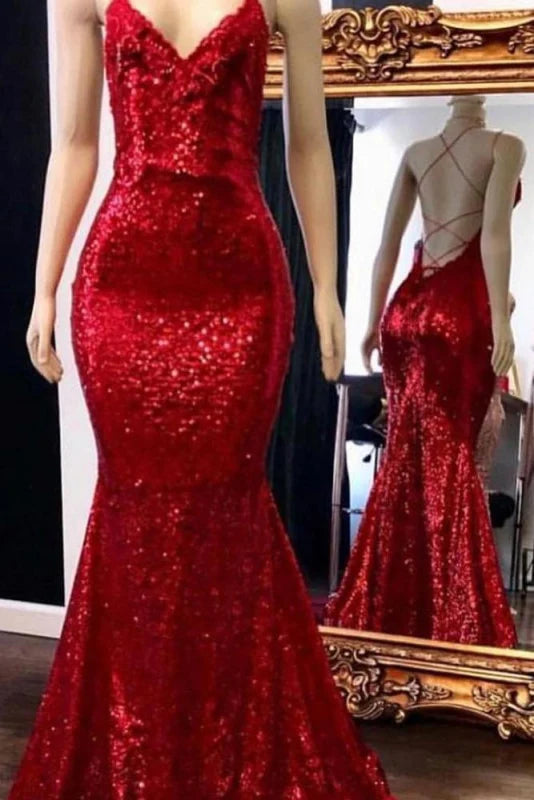 Woman wearing a sparkly mermaid sequin prom dress with spaghetti straps.