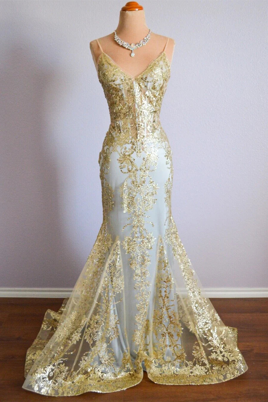 Woman wearing a sparkly mermaid prom dress with spaghetti straps and a V-neck.