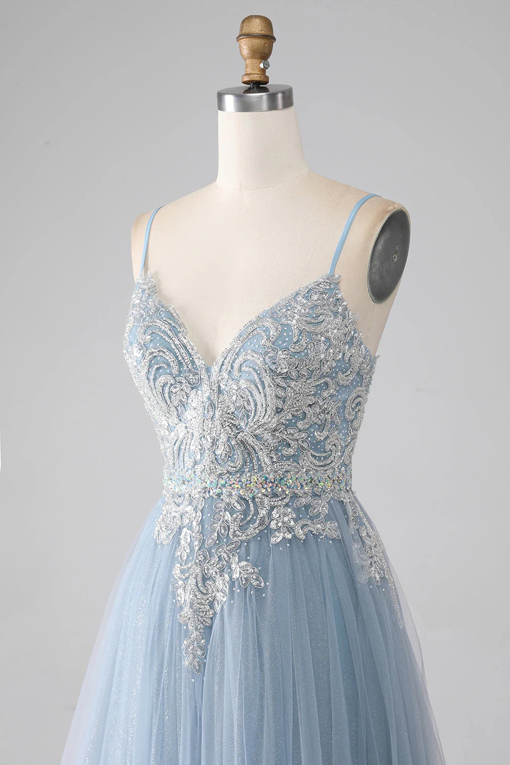 Close-up of the sparkly sequin detail on the grey-blue prom dress.