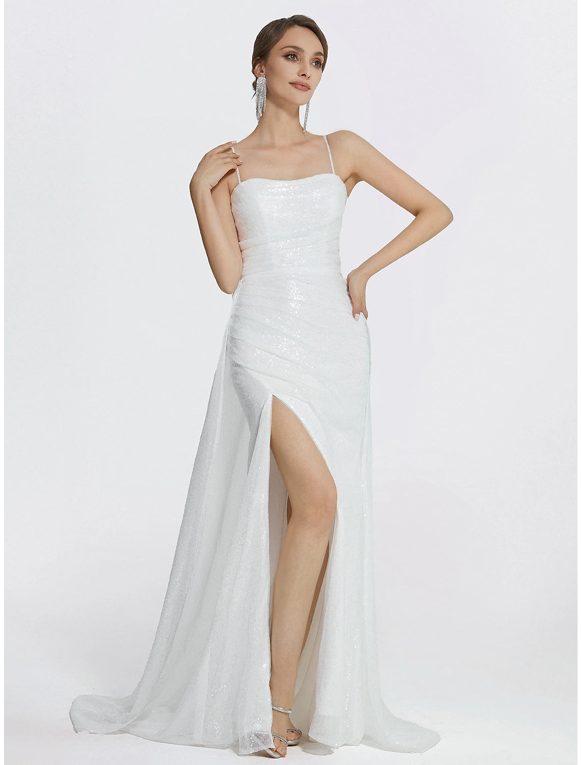 Side view of the woman in the sparkly mermaid trumpet dress, highlighting the ruched slit.