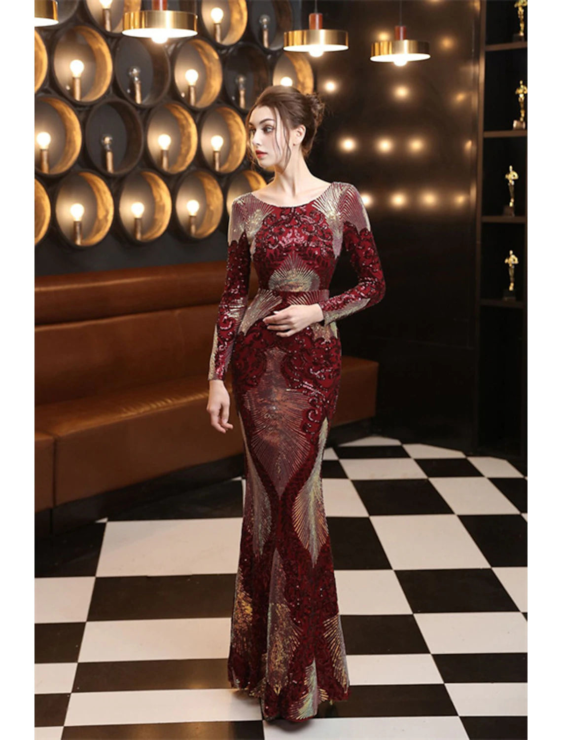 Full length view of a woman in a dazzling mermaid trumpet prom dress.
