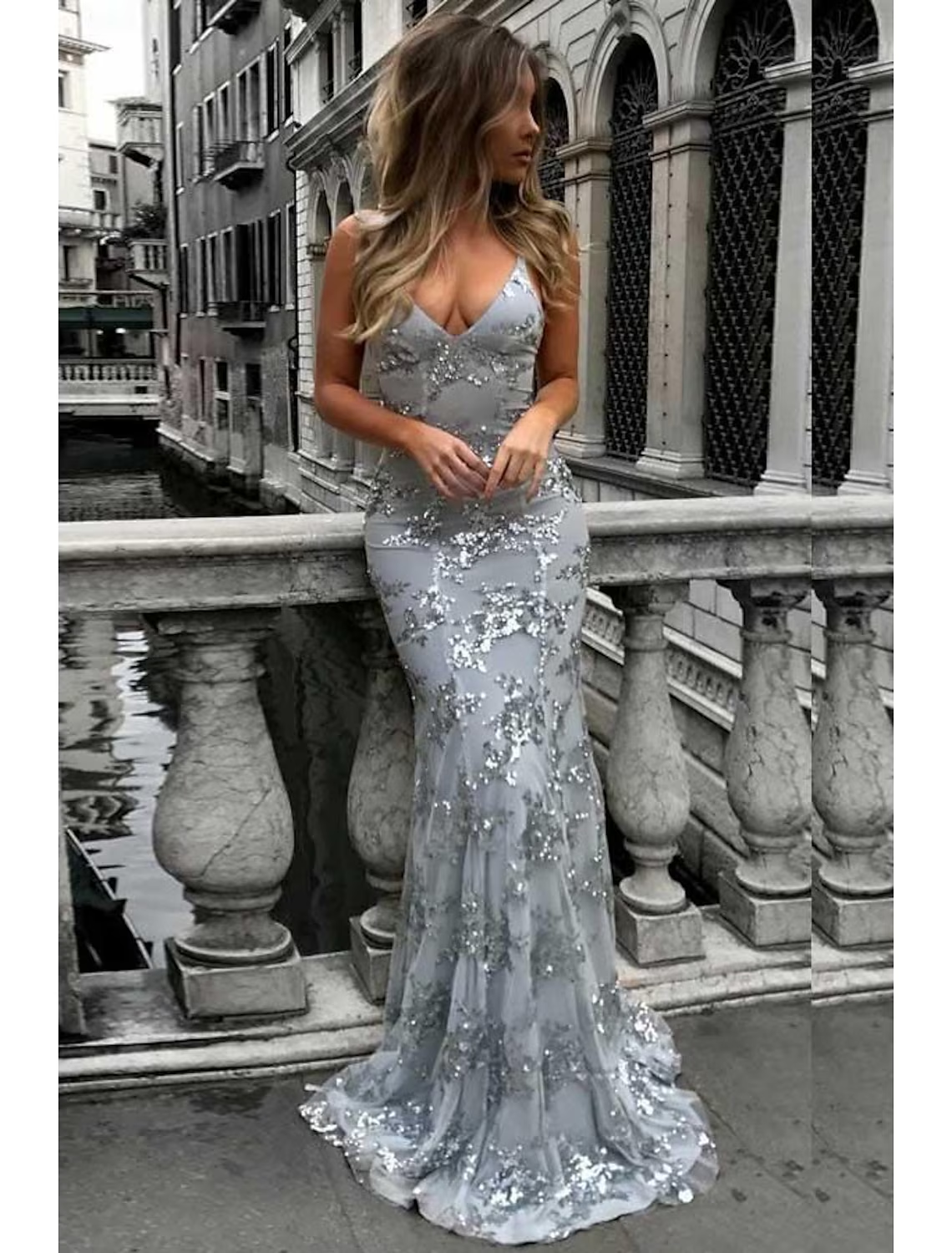 Sparkly mermaid trumpet prom dress with V-neck, lace, and sequins.