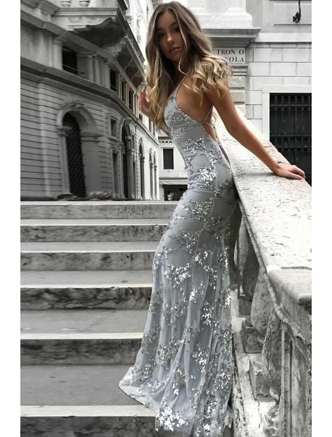 Back view of a sparkly mermaid trumpet prom dress with sweep train.