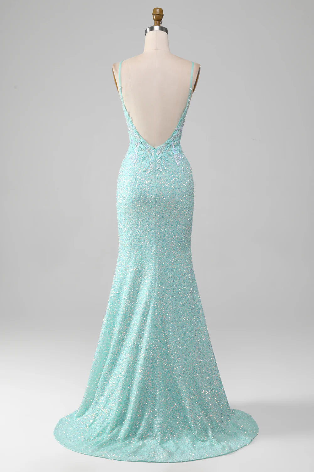 Back view of a woman in a light green sequined mermaid formal dress.