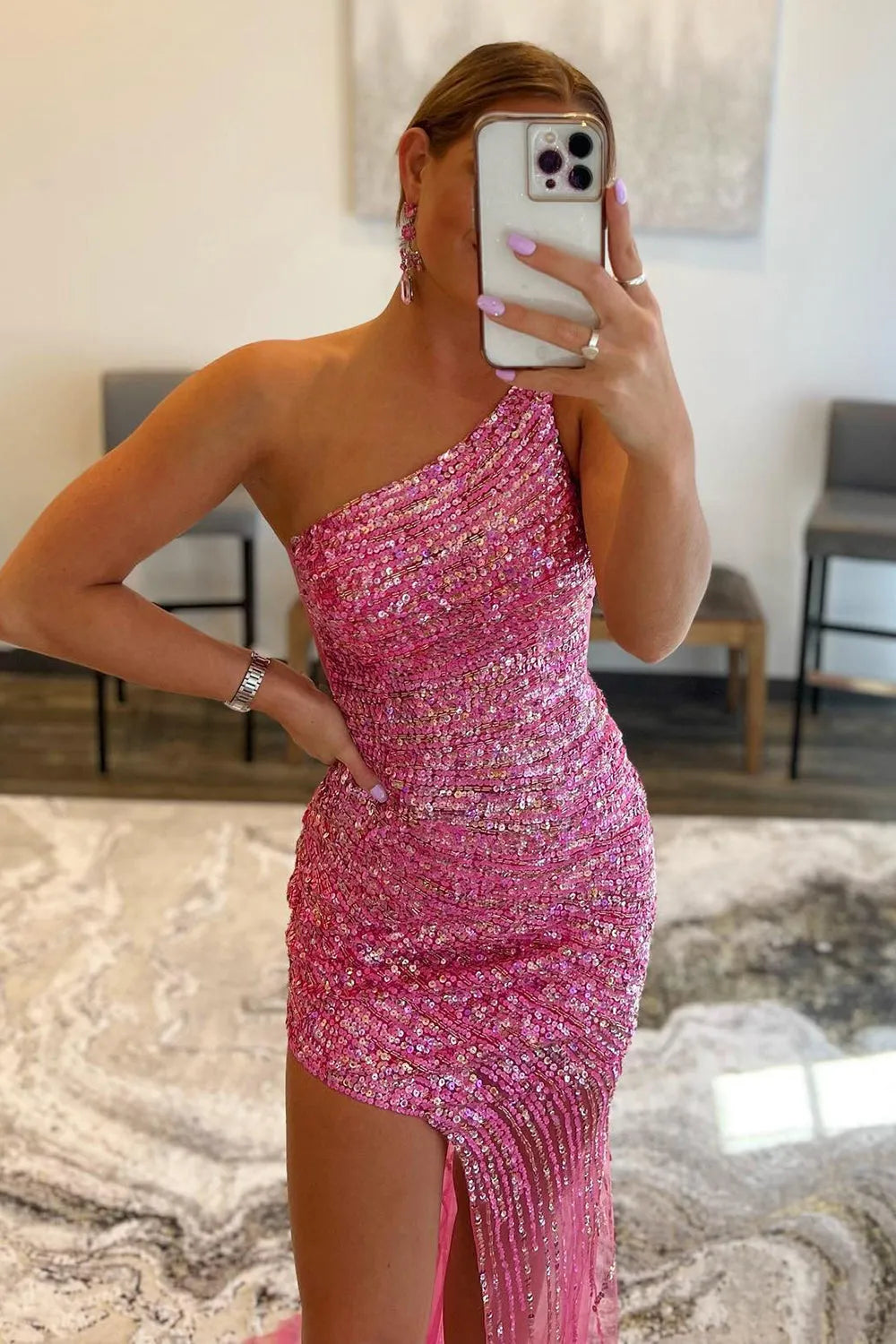 Close-up of the shimmering sequin fabric and one-shoulder neckline detail on the prom dress.
