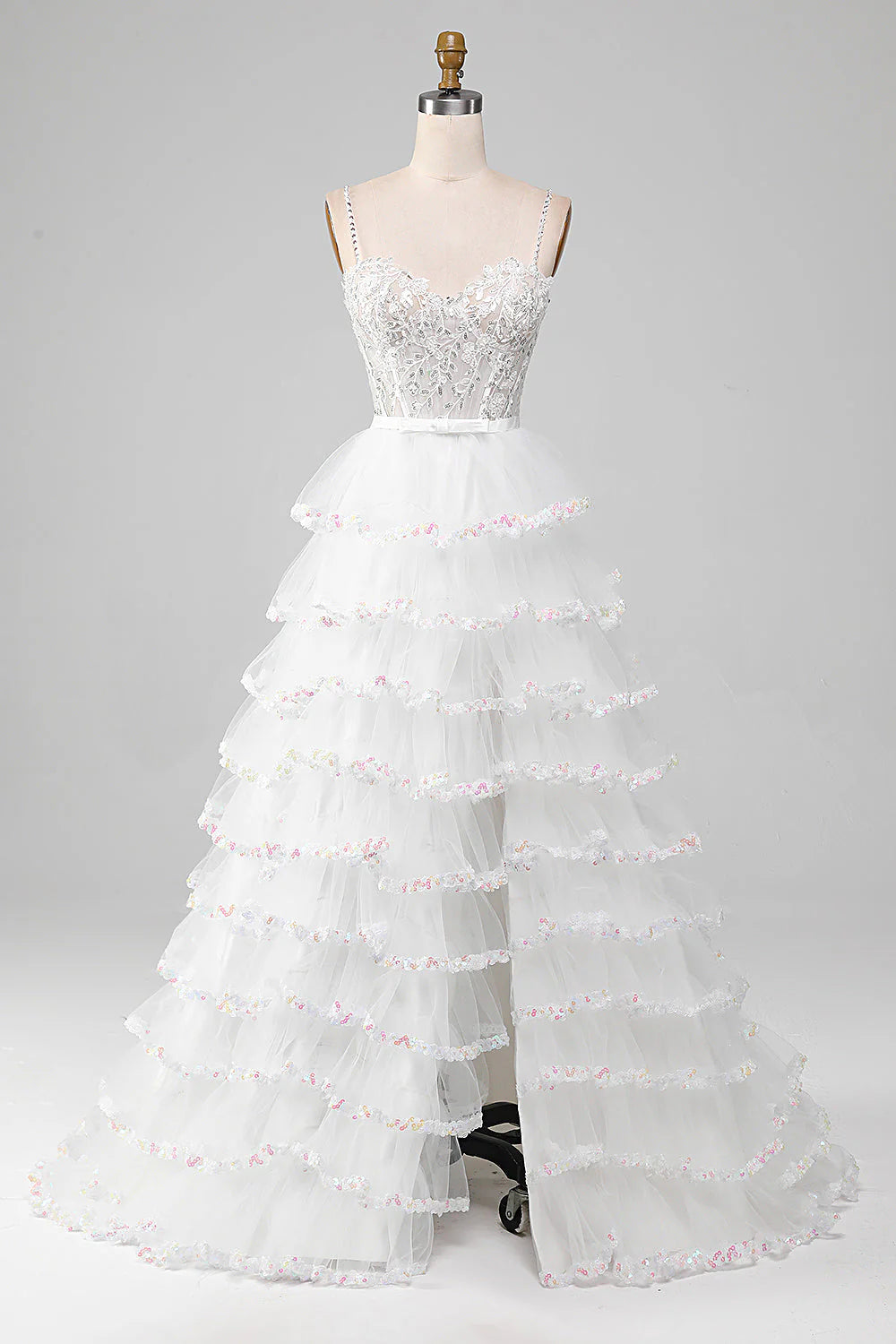 Model wearing a sparkly sequin A-line prom dress with a corset bodice and high slit.