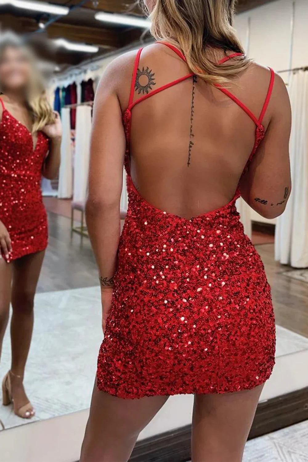 Back view of a woman in a sparkly sequin backless mini party dress.