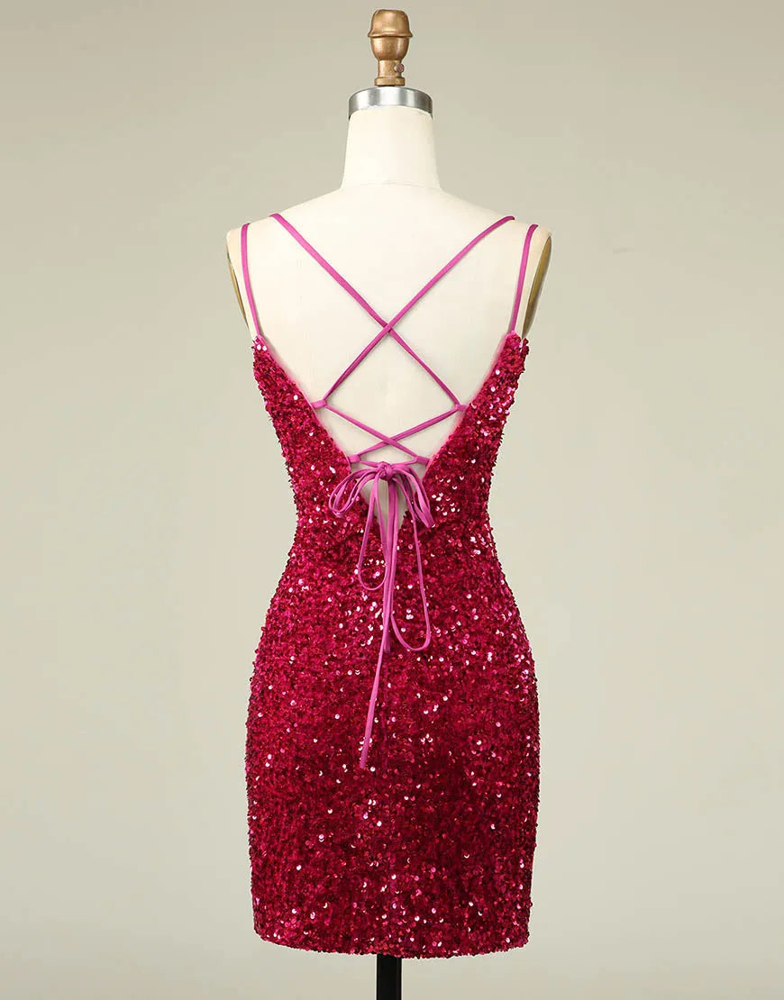 Model wearing a fuchsia sequin mini dress with double spaghetti straps, side view.