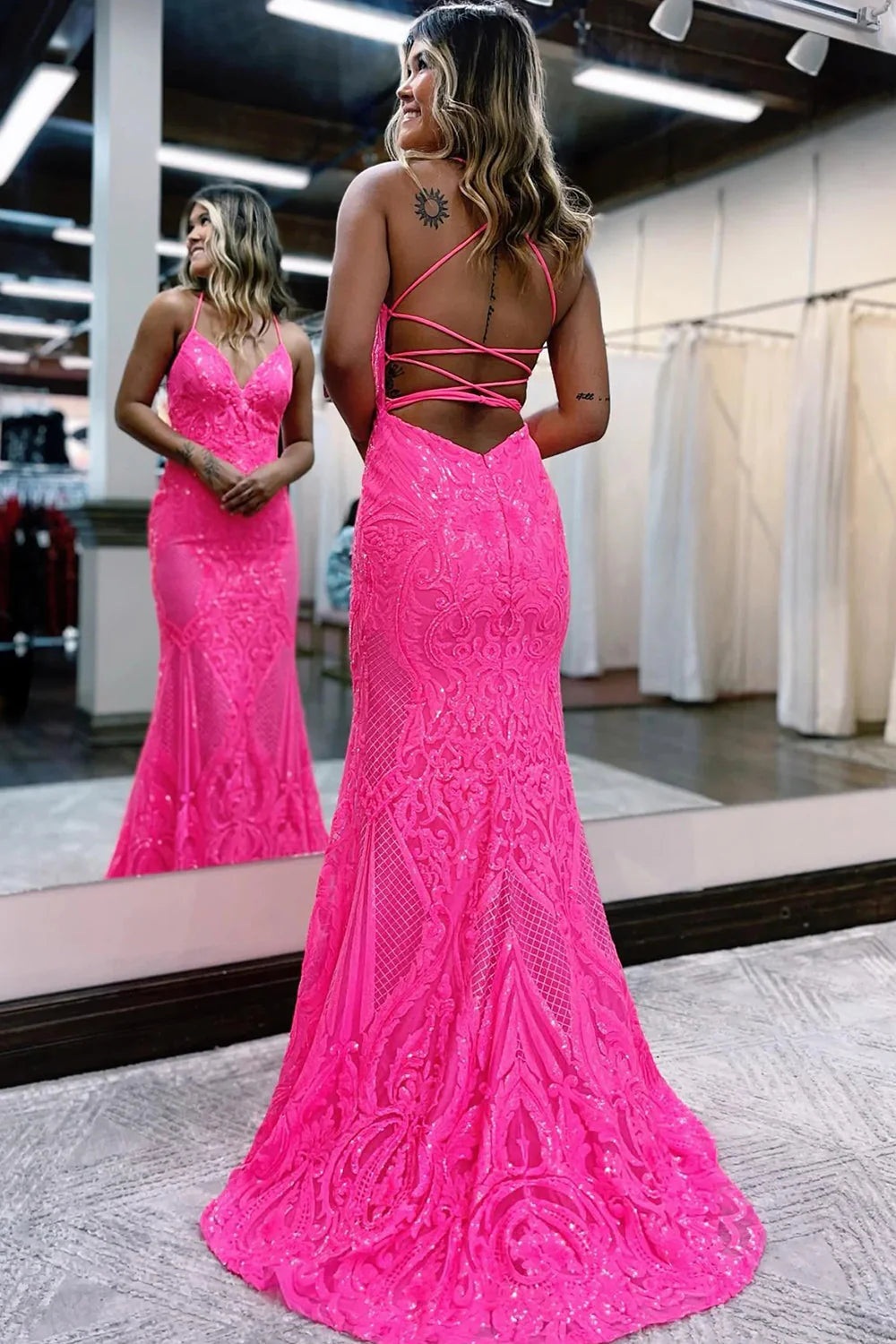 Full view of a sparkly mermaid formal gown, highlighting the sequin embellishments.