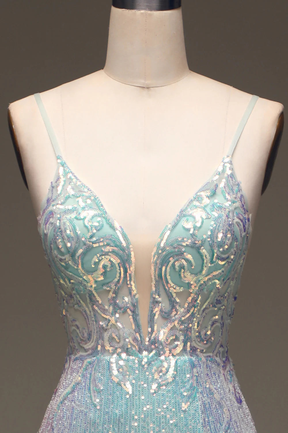 Close-up of the sequin detail and thigh split on a mermaid prom dress.