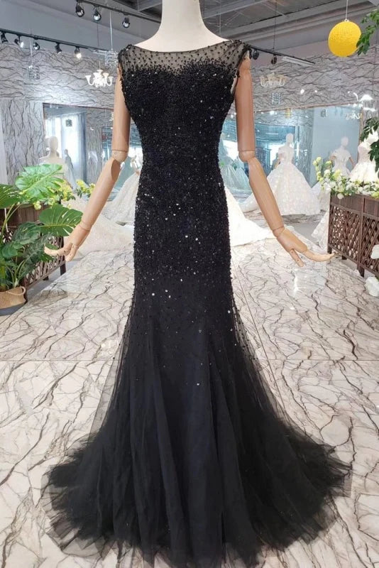 Woman wearing a sparkly mermaid prom dress with sequins and tulle.