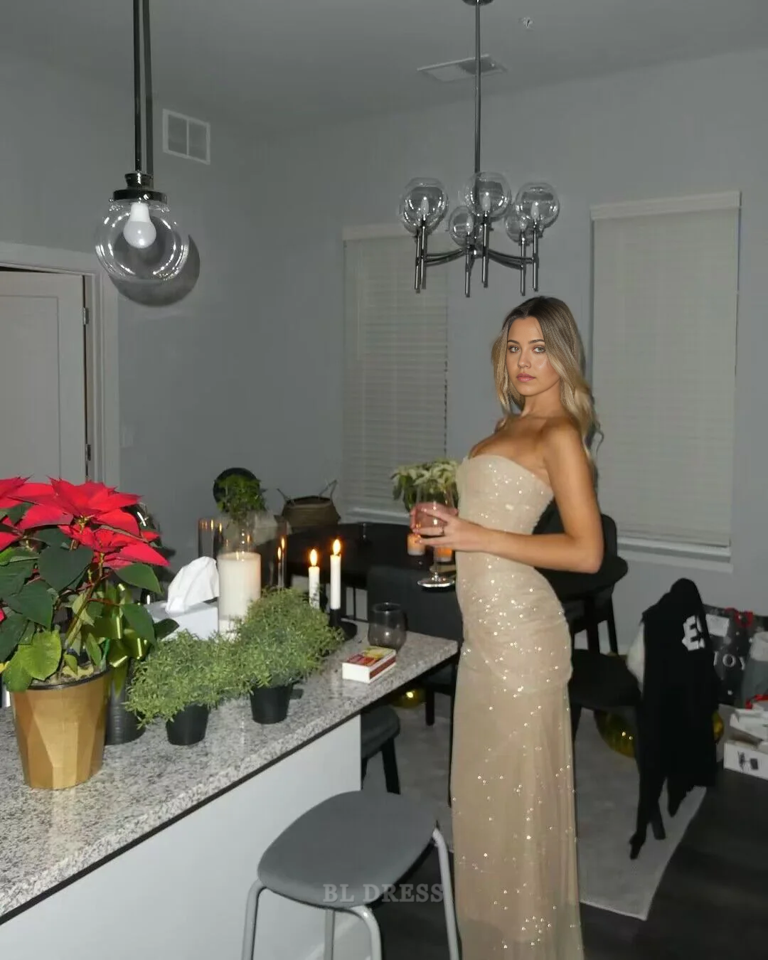 Model posing in a shimmering strapless formal dress.