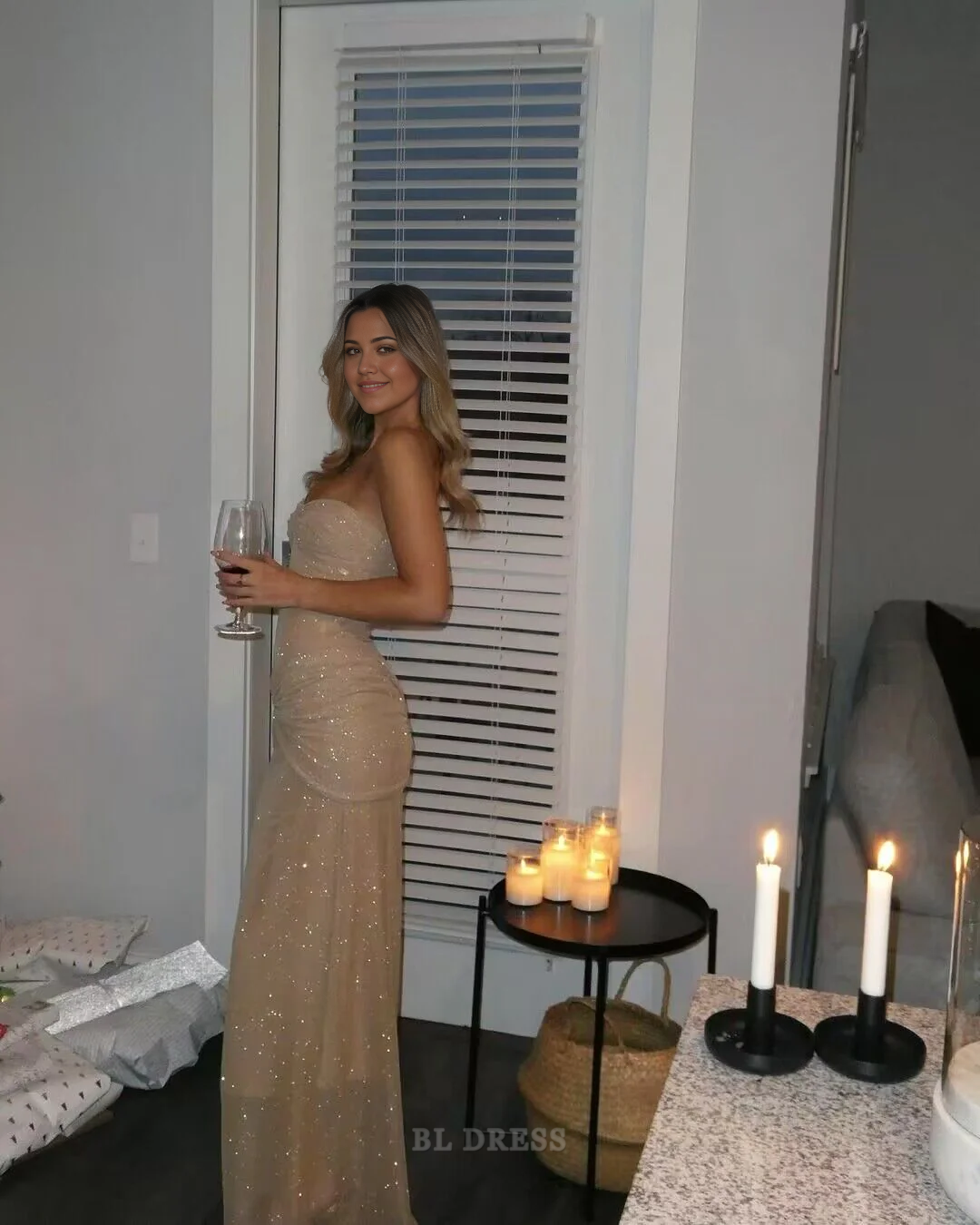 Full-length view of a woman in a sparkly strapless evening gown.