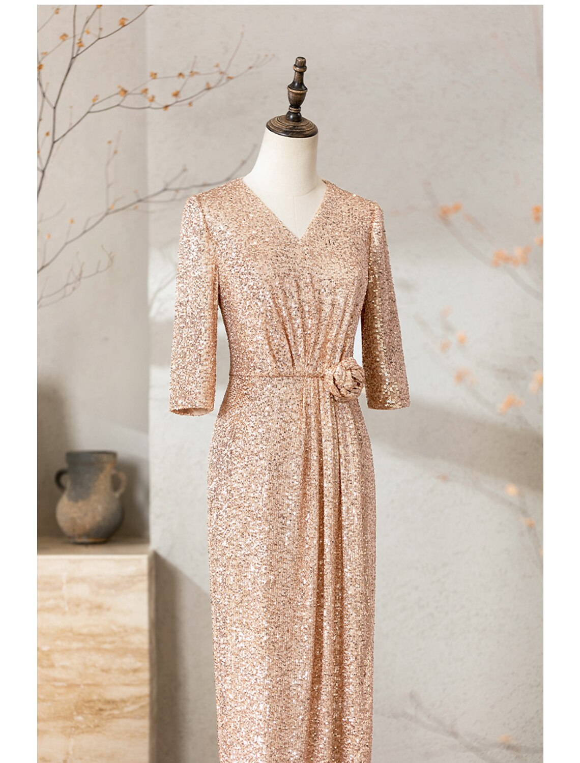 Back view of a woman in a sparkly navy blue sequined floor length dress.