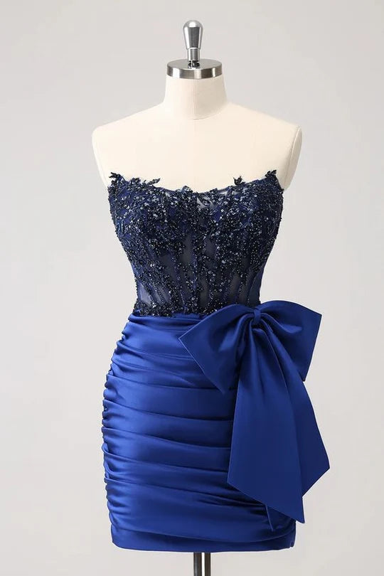 Woman wearing a sparkly strapless tight short homecoming dress with beaded appliques.